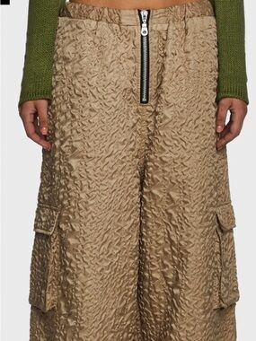 The Ragged Priest Tan Textured Wide-Leg
Parachute pants with exposed zipper
